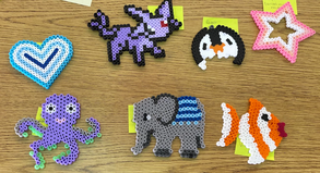 Seven finished fuse bead projects by students, including a cat, an elephant, and a star